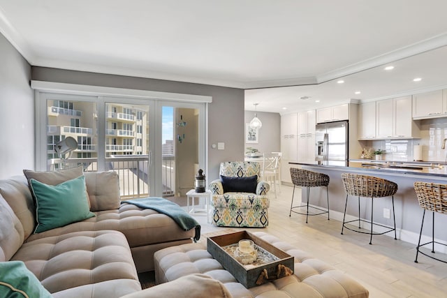 living room featuring recessed lighting, crown molding, and light wood finished floors