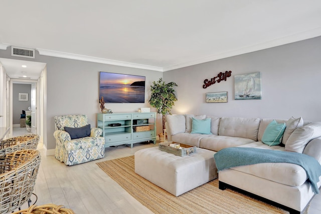 living room featuring baseboards, visible vents, crown molding, and wood finished floors