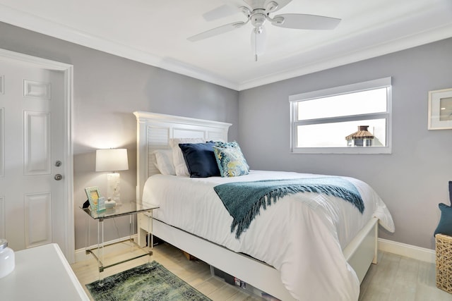 bedroom with ornamental molding, a ceiling fan, light wood-style flooring, and baseboards