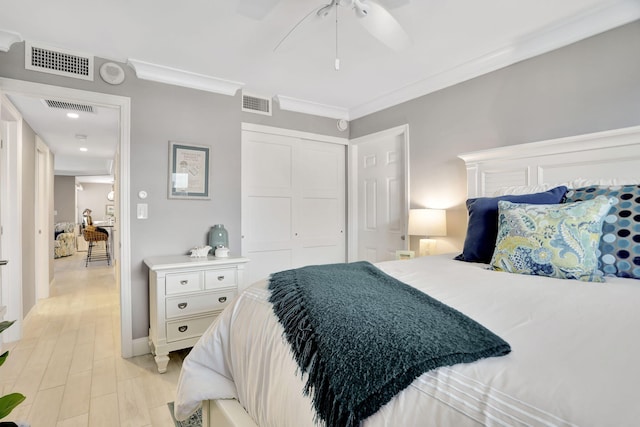 bedroom featuring ornamental molding, a closet, and visible vents