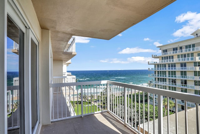 balcony with a water view and a beach view