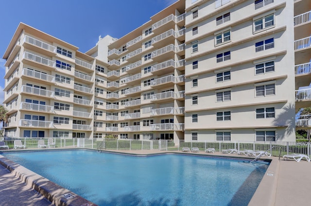 view of swimming pool featuring fence