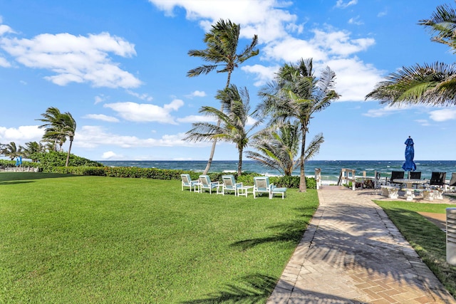 view of community featuring a yard and a water view