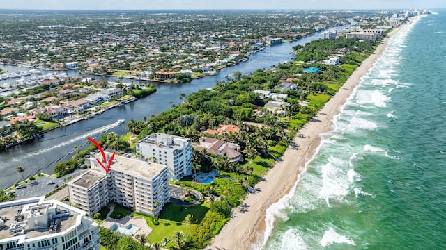 birds eye view of property featuring a water view and a view of the beach