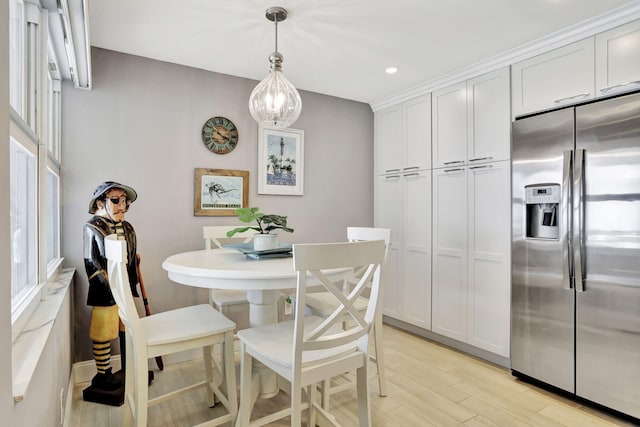 dining space with light wood finished floors and recessed lighting