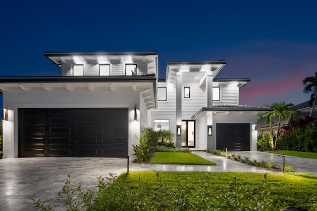 view of front facade featuring a garage and a front lawn