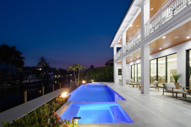 view of swimming pool with a patio and an in ground hot tub