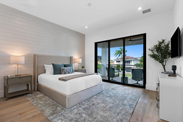 bedroom with light wood-type flooring and access to exterior