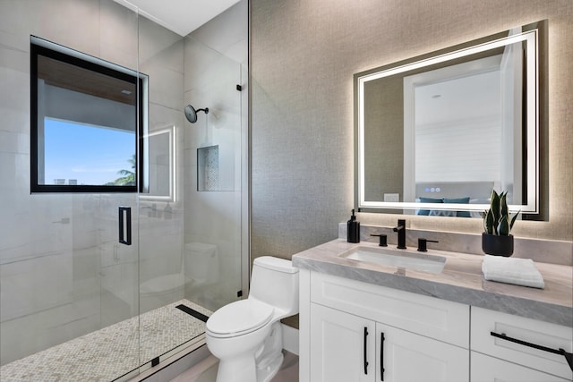 bathroom with vanity, toilet, and a shower with shower door