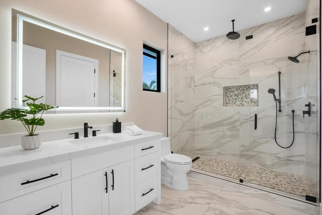 bathroom featuring vanity, toilet, and a shower with door