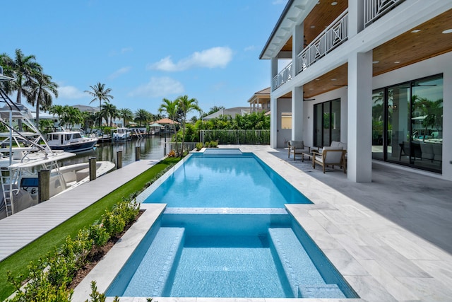 view of swimming pool featuring a water view and a patio area