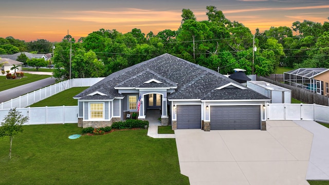 view of front of home with a yard and a garage