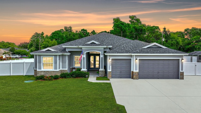 view of front of house featuring a yard and a garage