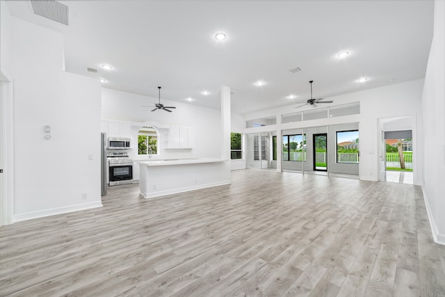 unfurnished living room featuring light hardwood / wood-style flooring and ceiling fan