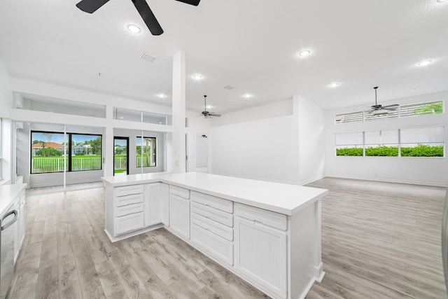 kitchen featuring stainless steel dishwasher, ceiling fan, white cabinets, and light hardwood / wood-style floors