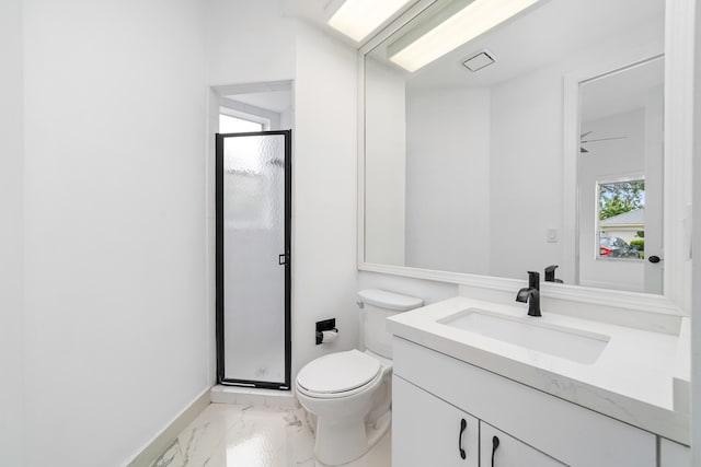 bathroom with vanity, toilet, ceiling fan, and a shower with shower door