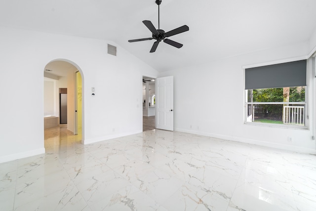 spare room with ceiling fan and vaulted ceiling