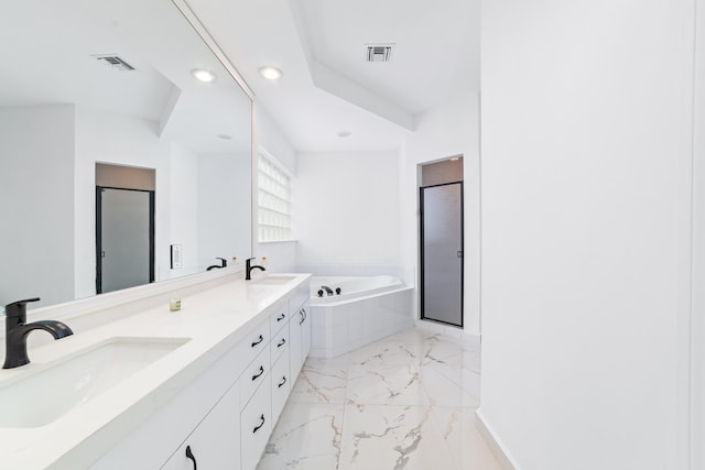 bathroom with vanity and shower with separate bathtub