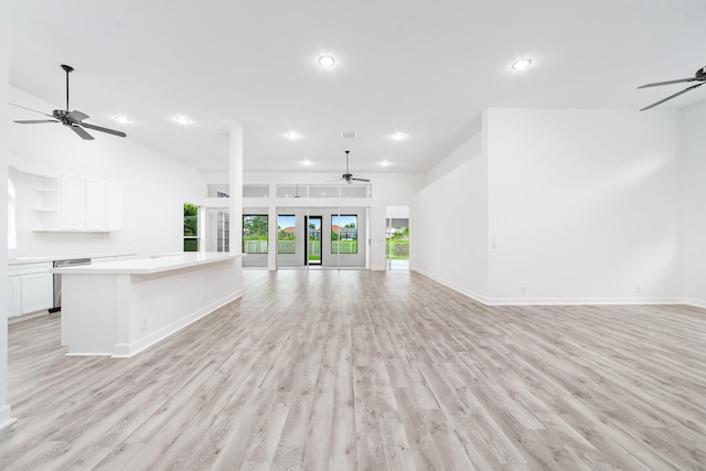 interior space with dishwasher, light hardwood / wood-style floors, a center island, white cabinetry, and ceiling fan