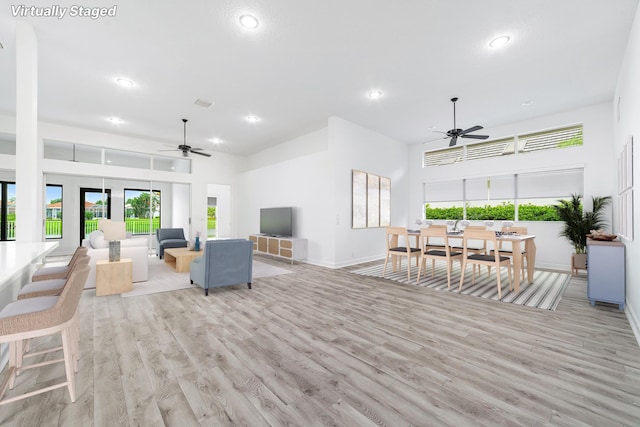 living room featuring ceiling fan and light hardwood / wood-style floors