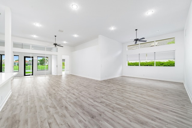 unfurnished living room with ceiling fan and light hardwood / wood-style floors