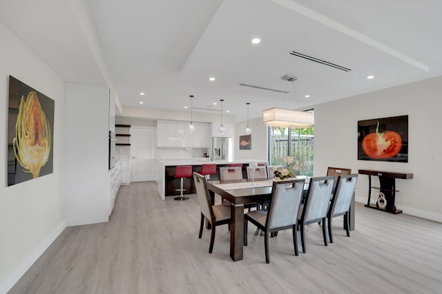 dining space featuring light wood-type flooring