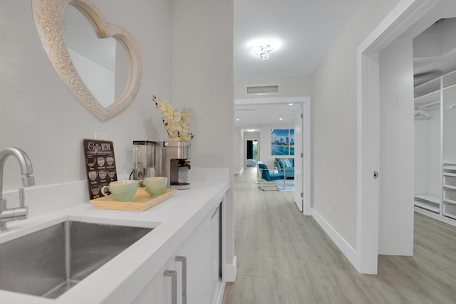 interior space featuring sink and light wood-type flooring