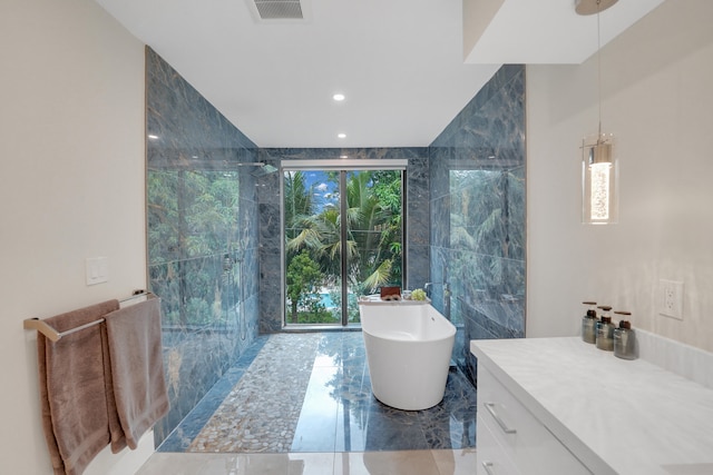 bathroom with shower with separate bathtub and vanity