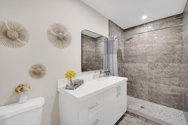 bathroom featuring curtained shower, toilet, and vanity