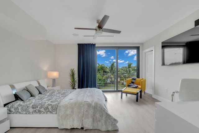 bedroom with a wall of windows, access to exterior, ceiling fan, and light hardwood / wood-style floors