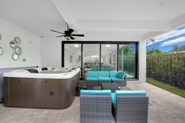 view of patio / terrace featuring ceiling fan, an outdoor living space, and a hot tub