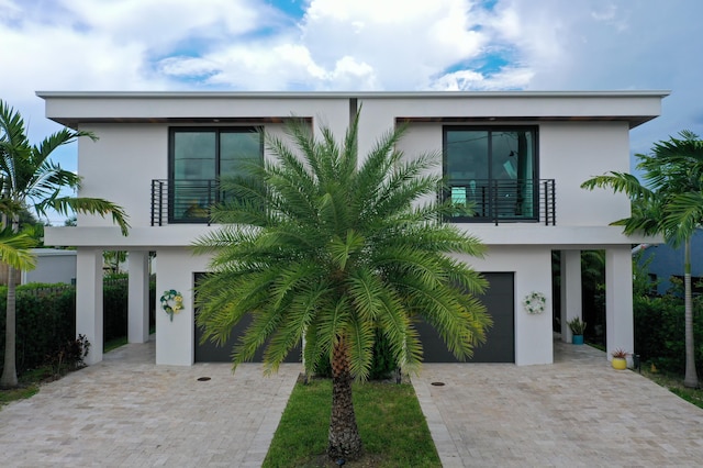 view of front of home featuring a garage and a balcony