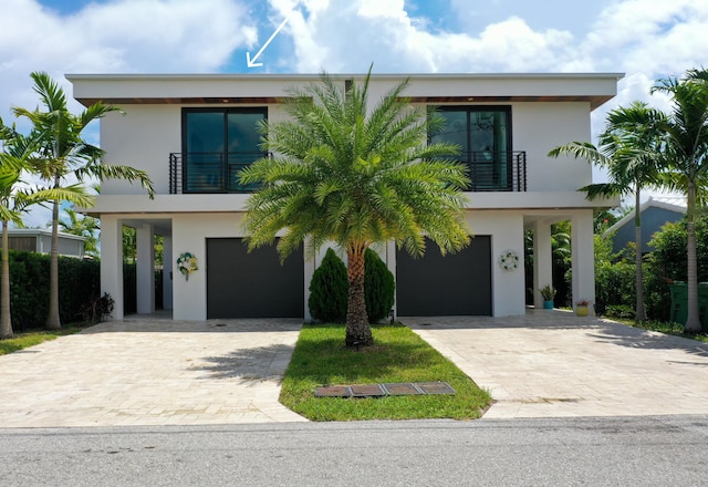 view of front facade featuring a garage and a balcony