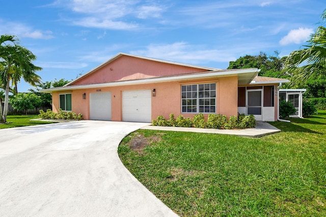 view of front of house with a front yard and a garage