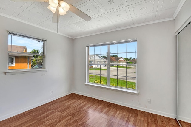 unfurnished room with ceiling fan, crown molding, and wood-type flooring