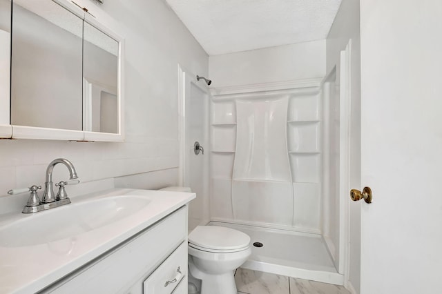 bathroom featuring toilet, walk in shower, vanity, a textured ceiling, and tasteful backsplash