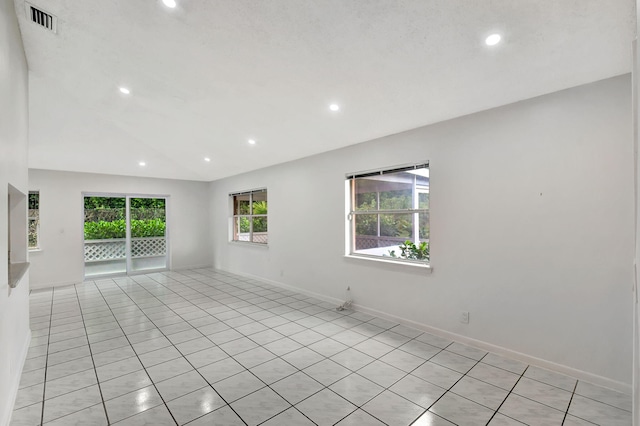 unfurnished living room featuring a textured ceiling and light tile patterned floors