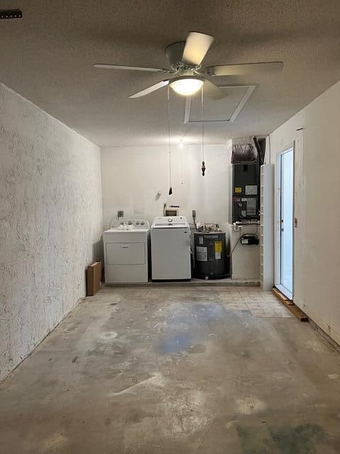 garage with water heater and washer and dryer