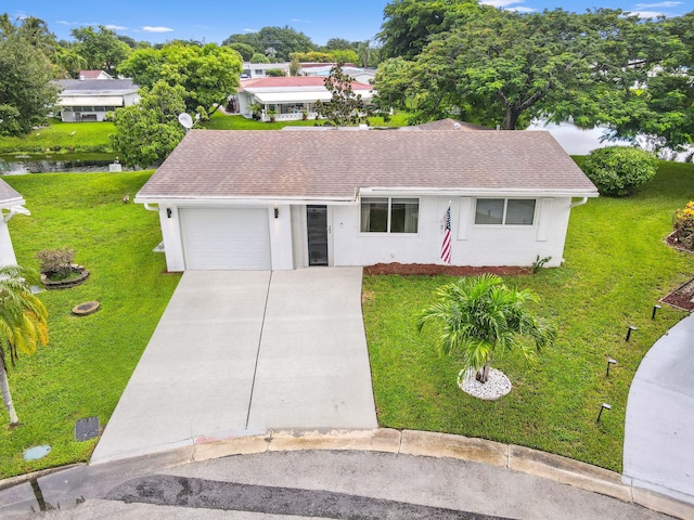 single story home featuring a front lawn, concrete driveway, a garage, and a shingled roof