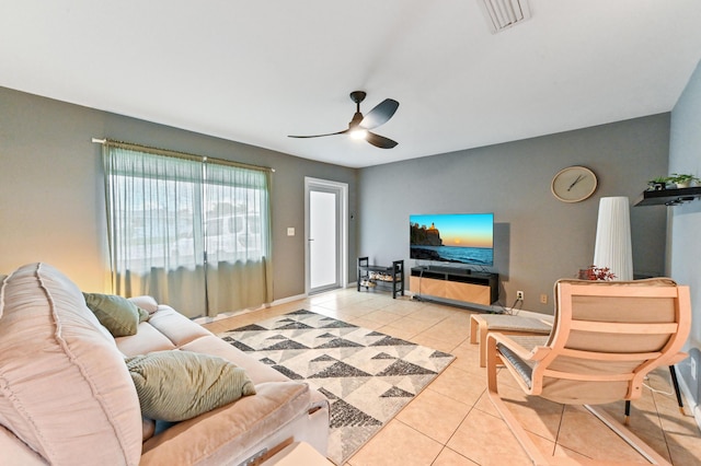 living room with ceiling fan and light tile patterned floors