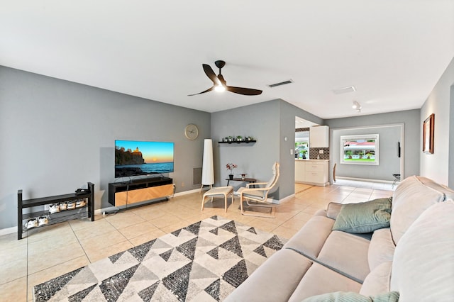 tiled living room featuring ceiling fan