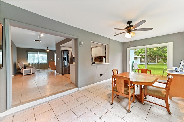 tiled dining space featuring ceiling fan