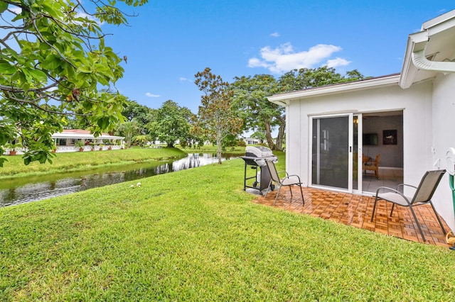 view of yard featuring a water view and a patio