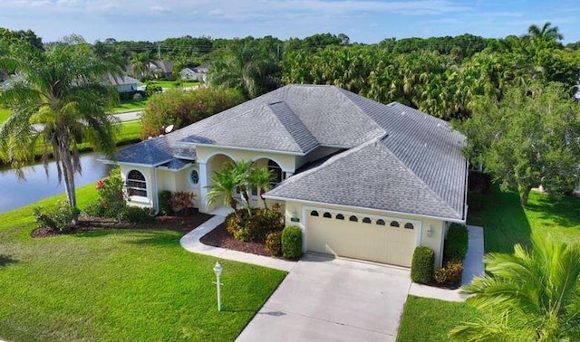 view of front of home featuring a garage and a front lawn