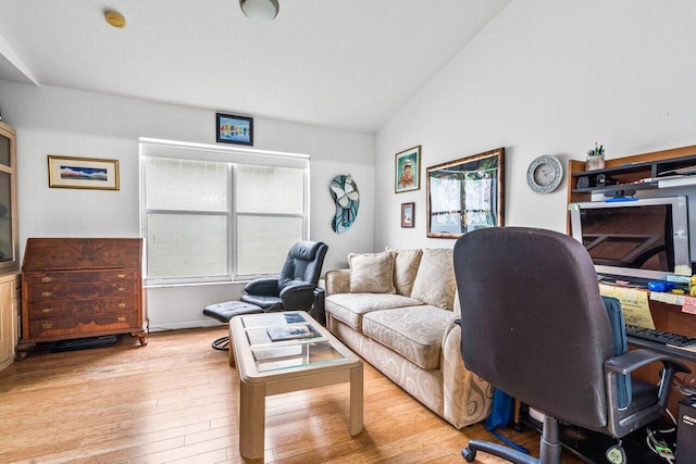 office space featuring vaulted ceiling and light hardwood / wood-style floors