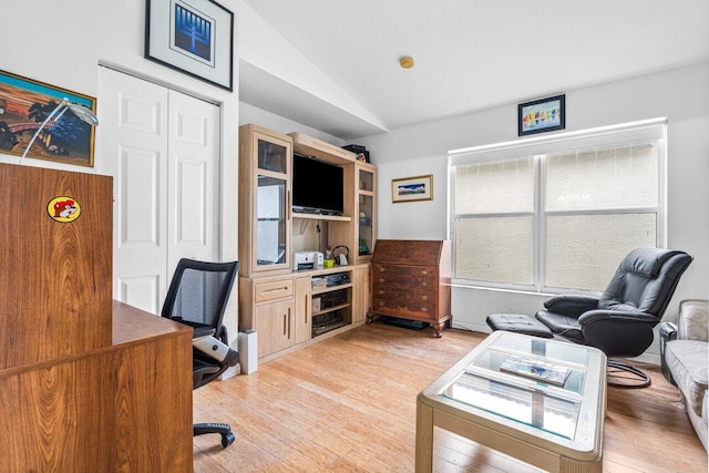 office space featuring lofted ceiling and light hardwood / wood-style floors