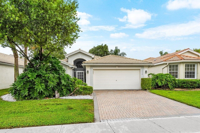 view of front of home with a garage and a front yard