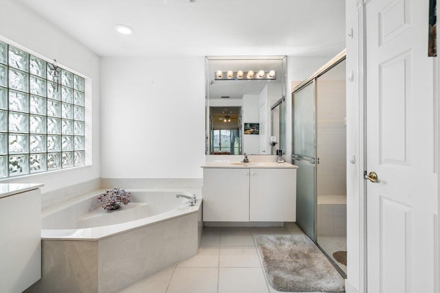 bathroom featuring vanity, a healthy amount of sunlight, and independent shower and bath