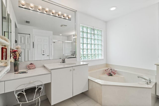 bathroom featuring tile patterned flooring, vanity, and plus walk in shower