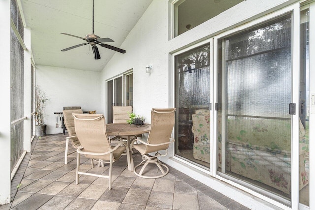 sunroom / solarium featuring ceiling fan and vaulted ceiling